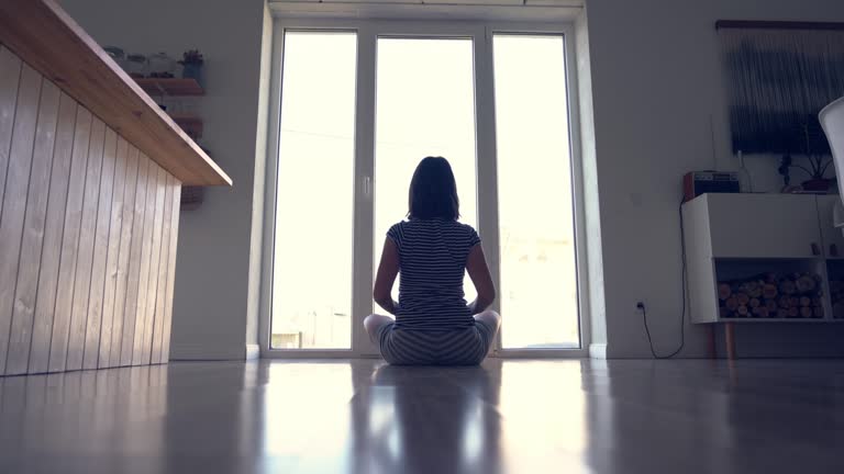 Open floor space near a window where someone might stretch during a short break